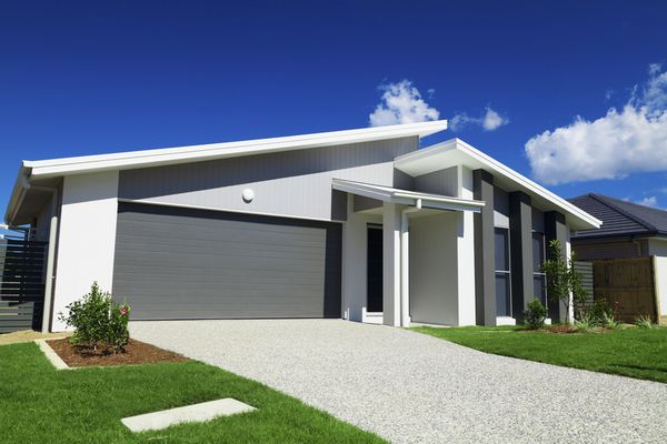 New suburban Australian house with small SOLD sign.